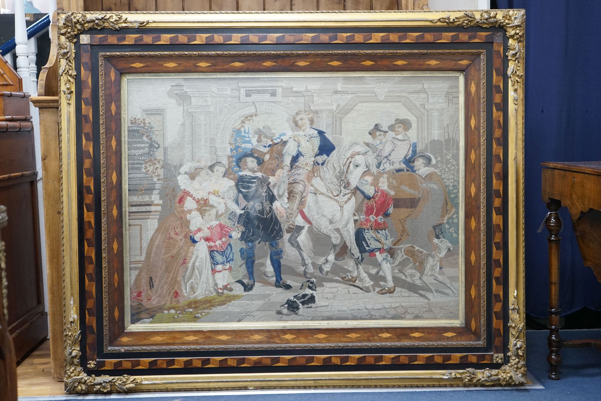 A 19th century Berlin tapestry panel in cubed parquetry and gilt gesso frame, width 146cm, height 120cm